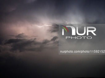 A lightning bolt illuminates the sky over northwest Syria, above the refugee camps, on September 20, 2024. The horizon flashes with the ligh...