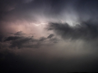 A lightning bolt illuminates the sky over northwest Syria, above the refugee camps, on September 20, 2024. The horizon flashes with the ligh...