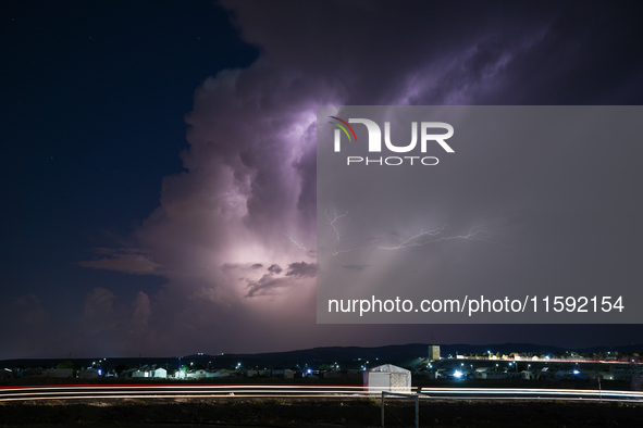 A lightning bolt illuminates the sky over northwest Syria, above the refugee camps, on September 20, 2024. The horizon flashes with the ligh...