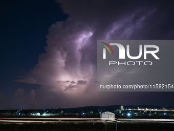 A lightning bolt illuminates the sky over northwest Syria, above the refugee camps, on September 20, 2024. The horizon flashes with the ligh...