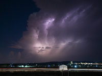 A lightning bolt illuminates the sky over northwest Syria, above the refugee camps, on September 20, 2024. The horizon flashes with the ligh...