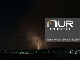 A lightning bolt illuminates the sky over northwest Syria, above the refugee camps, on September 20, 2024. The horizon flashes with the ligh...