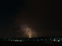 A lightning bolt illuminates the sky over northwest Syria, above the refugee camps, on September 20, 2024. The horizon flashes with the ligh...