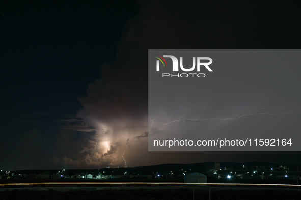 A lightning bolt illuminates the sky over northwest Syria, above the refugee camps, on September 20, 2024. The horizon flashes with the ligh...