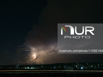 A lightning bolt illuminates the sky over northwest Syria, above the refugee camps, on September 20, 2024. The horizon flashes with the ligh...