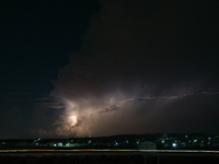 A lightning bolt illuminates the sky over northwest Syria, above the refugee camps, on September 20, 2024. The horizon flashes with the ligh...