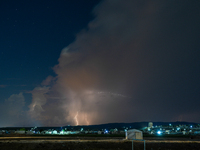 A lightning bolt illuminates the sky over northwest Syria, above the refugee camps, on September 20, 2024. The horizon flashes with the ligh...