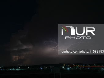 A lightning bolt illuminates the sky over northwest Syria, above the refugee camps, on September 20, 2024. The horizon flashes with the ligh...