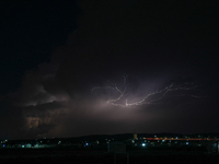 A lightning bolt illuminates the sky over northwest Syria, above the refugee camps, on September 20, 2024. The horizon flashes with the ligh...