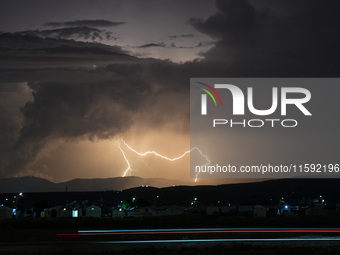 A lightning bolt illuminates the sky over northwest Syria, above the refugee camps, on September 20, 2024. The horizon flashes with the ligh...