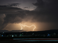 A lightning bolt illuminates the sky over northwest Syria, above the refugee camps, on September 20, 2024. The horizon flashes with the ligh...