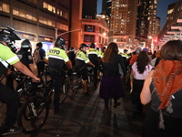 Protesters demonstrate as NYPD watches. Protesters demonstrate and make their voices heard for Black and Palestinian liberation following th...