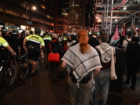 Protesters march while police follow. Protesters demonstrate and make their voices heard for Black and Palestinian liberation following the...