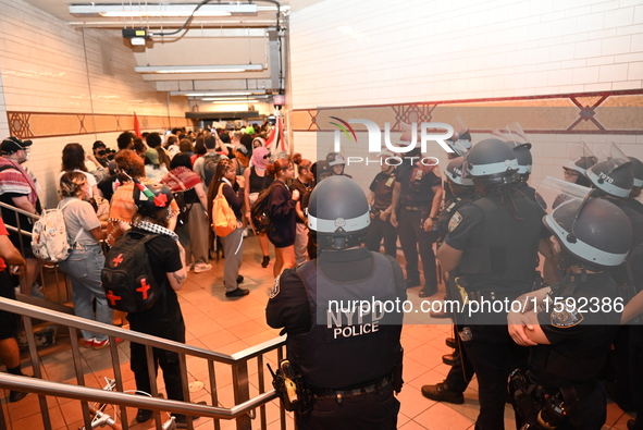 Protesters demonstrate inside the subway. Protesters call for black and Palestinian liberation following the subway shooting in Brooklyn, st...