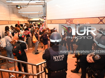 Protesters demonstrate inside the subway. Protesters call for black and Palestinian liberation following the subway shooting in Brooklyn, st...