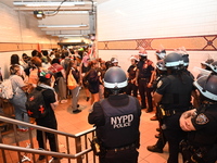 Protesters demonstrate inside the subway. Protesters call for black and Palestinian liberation following the subway shooting in Brooklyn, st...