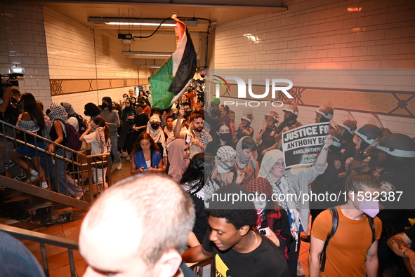 Protesters demonstrate inside the subway. Protesters call for black and Palestinian liberation following the subway shooting in Brooklyn, st...