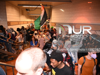 Protesters demonstrate inside the subway. Protesters call for black and Palestinian liberation following the subway shooting in Brooklyn, st...