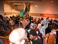 Protesters demonstrate inside the subway. Protesters call for black and Palestinian liberation following the subway shooting in Brooklyn, st...