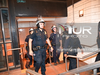 Police guard the subway. Protesters demonstrate and make their voices heard for black and Palestinian liberation following the subway shooti...