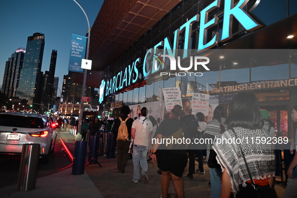 Protesters demonstrate by Barclays Center. Protesters make their voices heard for black and Palestinian liberation following the subway shoo...