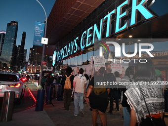 Protesters demonstrate by Barclays Center. Protesters make their voices heard for black and Palestinian liberation following the subway shoo...