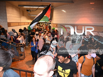 Protesters demonstrate inside a subway. Protesters demonstrate and make their voices heard for Black and Palestinian liberation following th...