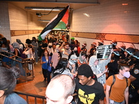 Protesters demonstrate inside a subway. Protesters demonstrate and make their voices heard for Black and Palestinian liberation following th...