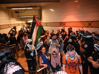 Protesters inside the subway. Protesters demonstrate and make their voices heard for black and Palestinian liberation following the subway s...