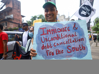 A Nepali activist displays a slogan calling for climate justice during a march to mark the Global Week of Action for Peace and Climate Justi...