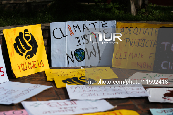 Placards display slogans calling for climate justice during an event to mark Global Week of Action for Peace and Climate Justice in Lalitpur...