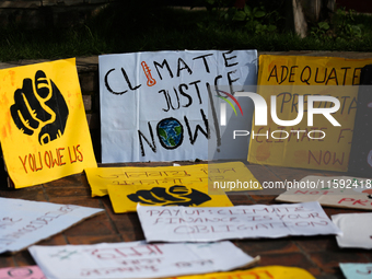 Placards display slogans calling for climate justice during an event to mark Global Week of Action for Peace and Climate Justice in Lalitpur...