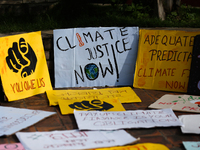 Placards display slogans calling for climate justice during an event to mark Global Week of Action for Peace and Climate Justice in Lalitpur...