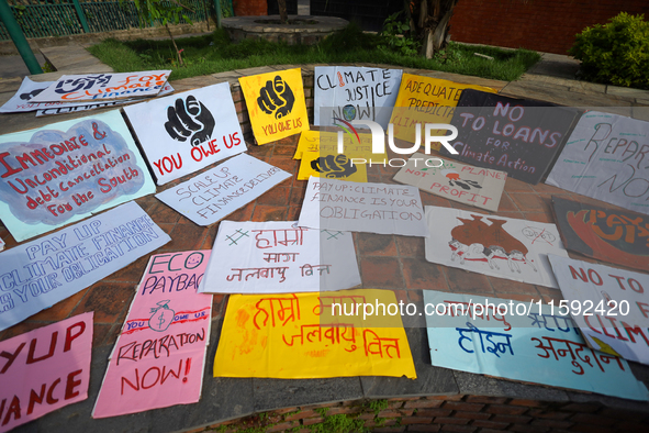 Placards display slogans calling for climate justice during an event to mark Global Week of Action for Peace and Climate Justice in Lalitpur...