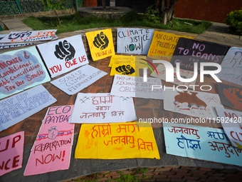 Placards display slogans calling for climate justice during an event to mark Global Week of Action for Peace and Climate Justice in Lalitpur...