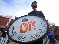 A Nepali activist displays a slogan calling for climate justice during a march to mark the Global Week of Action for Peace and Climate Justi...