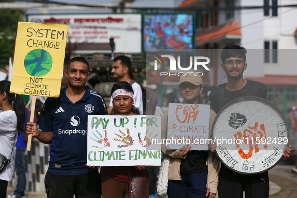 Nepali activists display slogans calling for climate justice during a march to mark Global Week of Action for Peace and Climate Justice in L...