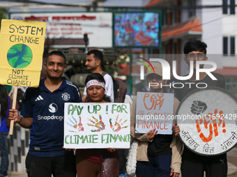 Nepali activists display slogans calling for climate justice during a march to mark Global Week of Action for Peace and Climate Justice in L...