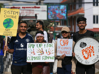 Nepali activists display slogans calling for climate justice during a march to mark Global Week of Action for Peace and Climate Justice in L...