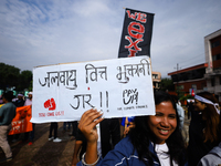 A Nepali activist displays a slogan calling for climate justice during a march to mark the Global Week of Action for Peace and Climate Justi...