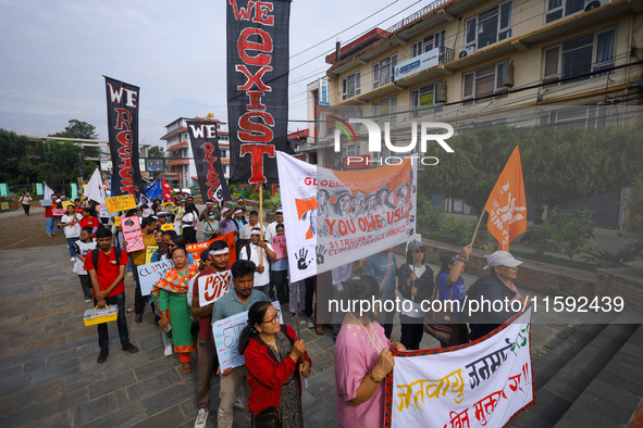 Nepali activists display slogans calling for climate justice during a march to mark Global Week of Action for Peace and Climate Justice in L...