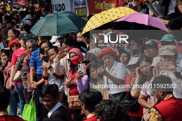 The residents watch the 'Gotong Toapekong' (Carrying Toapekong) tradition in Tangerang, Banten Province, Indonesia, on September 21, 2024. T...