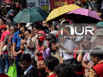 The residents watch the 'Gotong Toapekong' (Carrying Toapekong) tradition in Tangerang, Banten Province, Indonesia, on September 21, 2024. T...