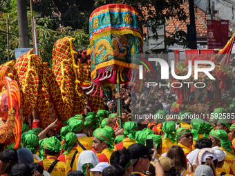 The atmosphere of the 'Gotong Toapekong' (Carrying Toapekong) tradition in Tangerang, Banten Province, Indonesia, on September 21, 2024. Thi...