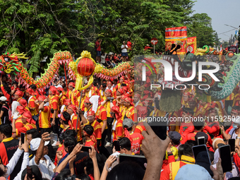 The atmosphere of the 'Gotong Toapekong' (Carrying Toapekong) tradition in Tangerang, Banten Province, Indonesia, on September 21, 2024. Thi...