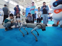 Visitors watch a performance of a four-legged robot during the 2024 National Science Popularization Day in Beijing, China, on September 21,...