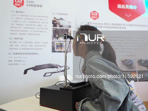 A child uses ''AR smart glasses'' during the 2024 National Science Popularization Day in Beijing, China, on September 21, 2024. 