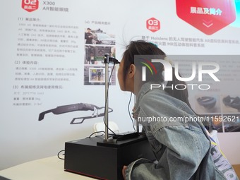 A child uses ''AR smart glasses'' during the 2024 National Science Popularization Day in Beijing, China, on September 21, 2024. (