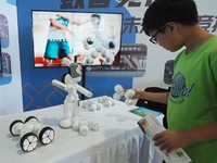 A child interacts with a robot during the 2024 National Science Popularization Day in Beijing, China, on September 21, 2024. (