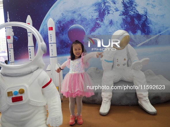 A child plays a game in the space experience area during the 2024 National Science Popularization Day in Beijing, China, on September 21, 20...